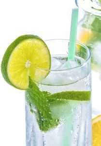 A cold drink with ice, mint and lime.