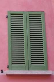 Green external shutters on a window, illustrating external shading.